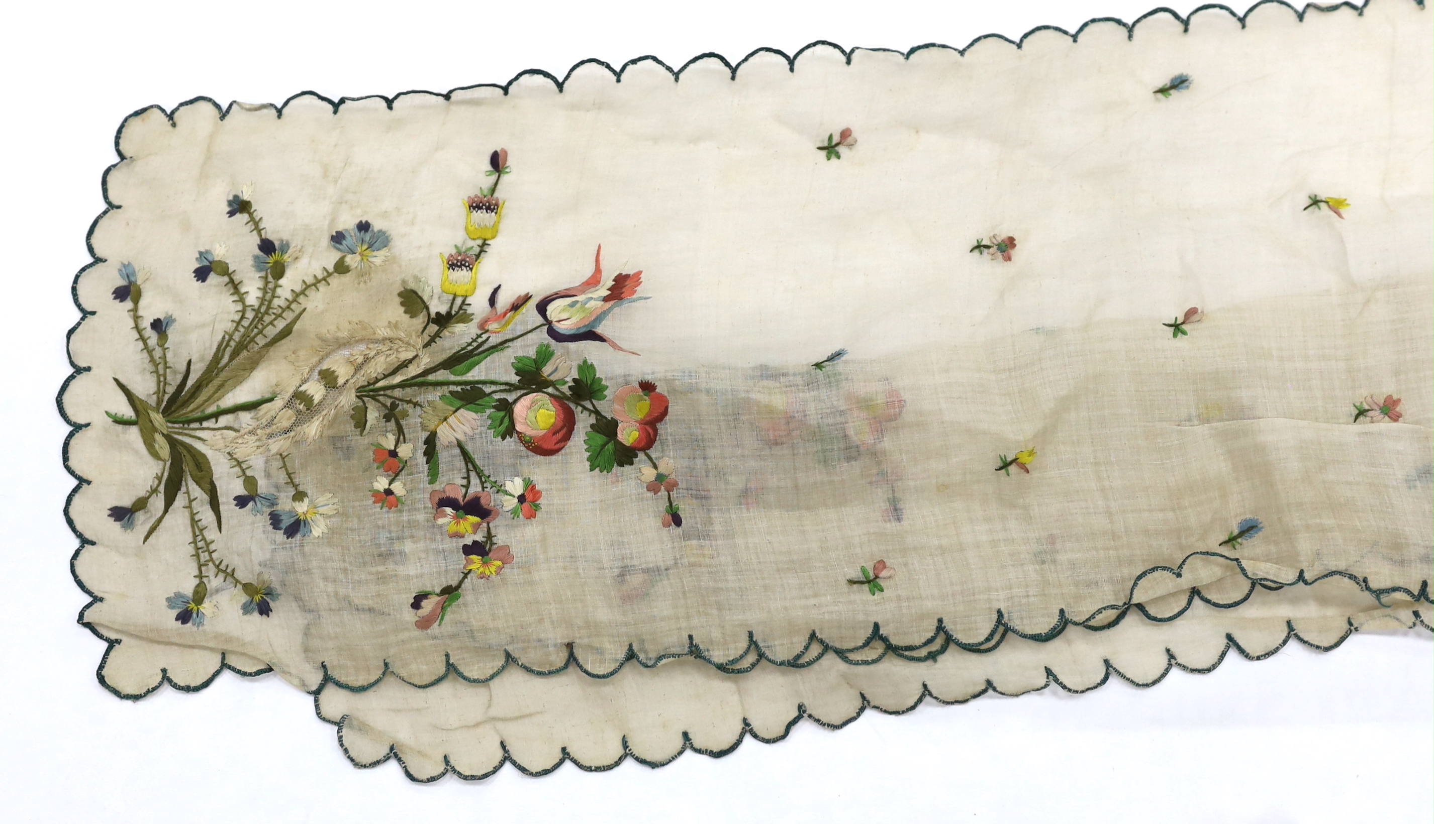 A late 18th century green silk scalloped bordered lady’s apron border, ornately embroidered with gold metallic threads and polychrome silk, in a large vine, floral and leaf design, together with a similar cream silk embr